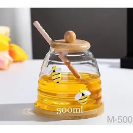 Mbajtese Mjalti Qelq 500ml me Kapak Luge dhe Bazament Druri - ShikoCmimin